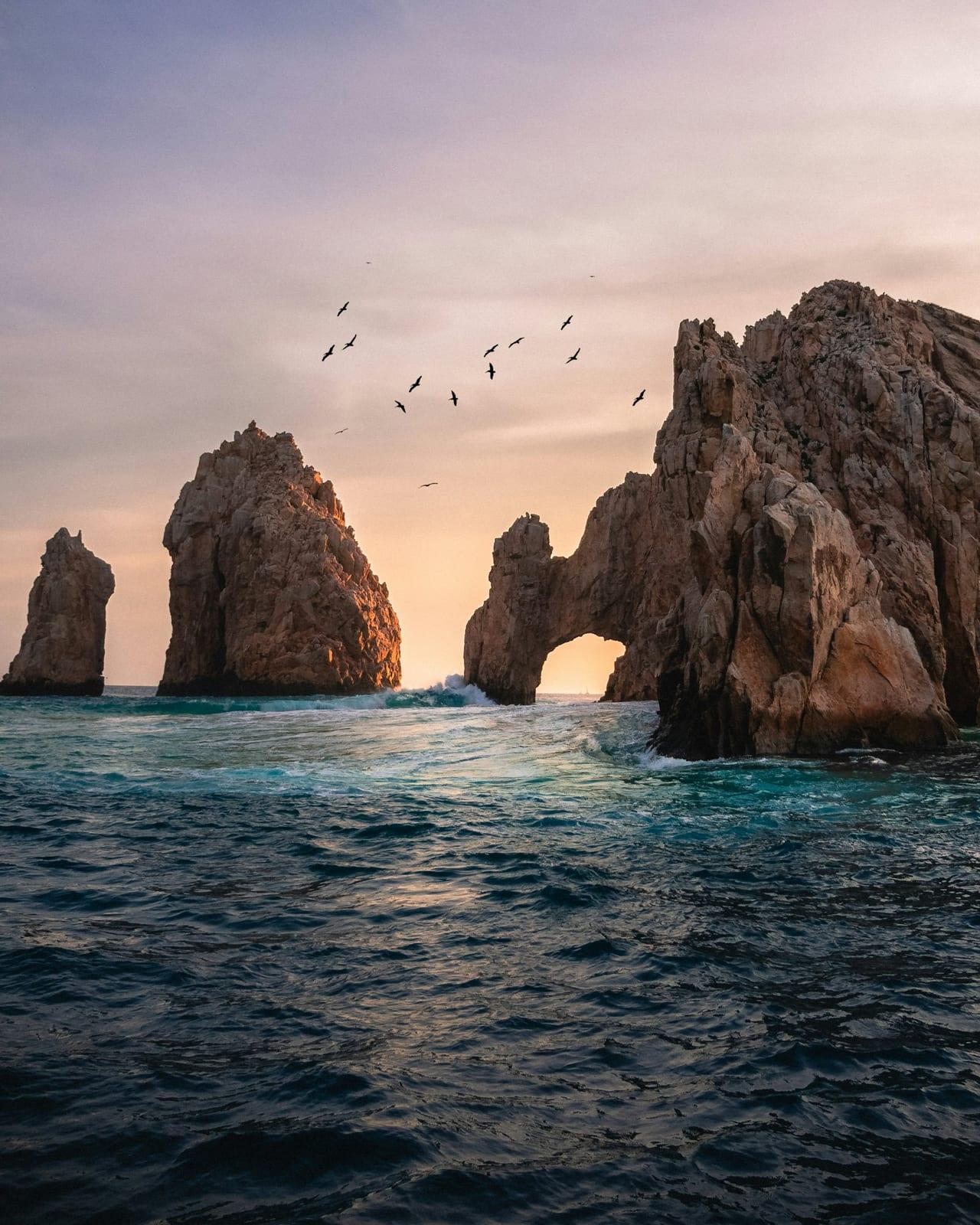 The rock arch of Land’s End rising from the sea at Cabo San Lucas at sunset