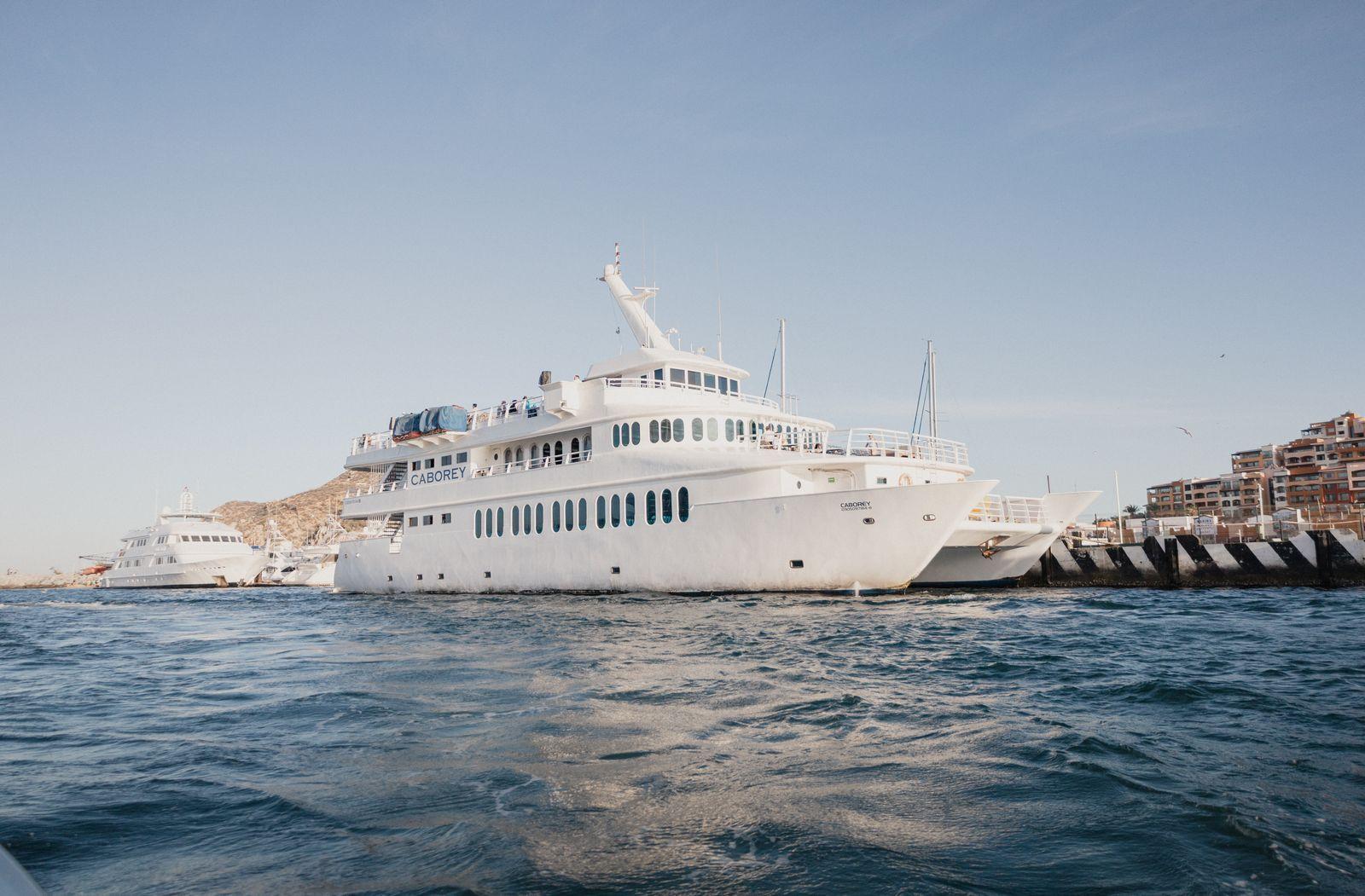 Luxury yacht docked at the Cabo San Lucas marina at dusk