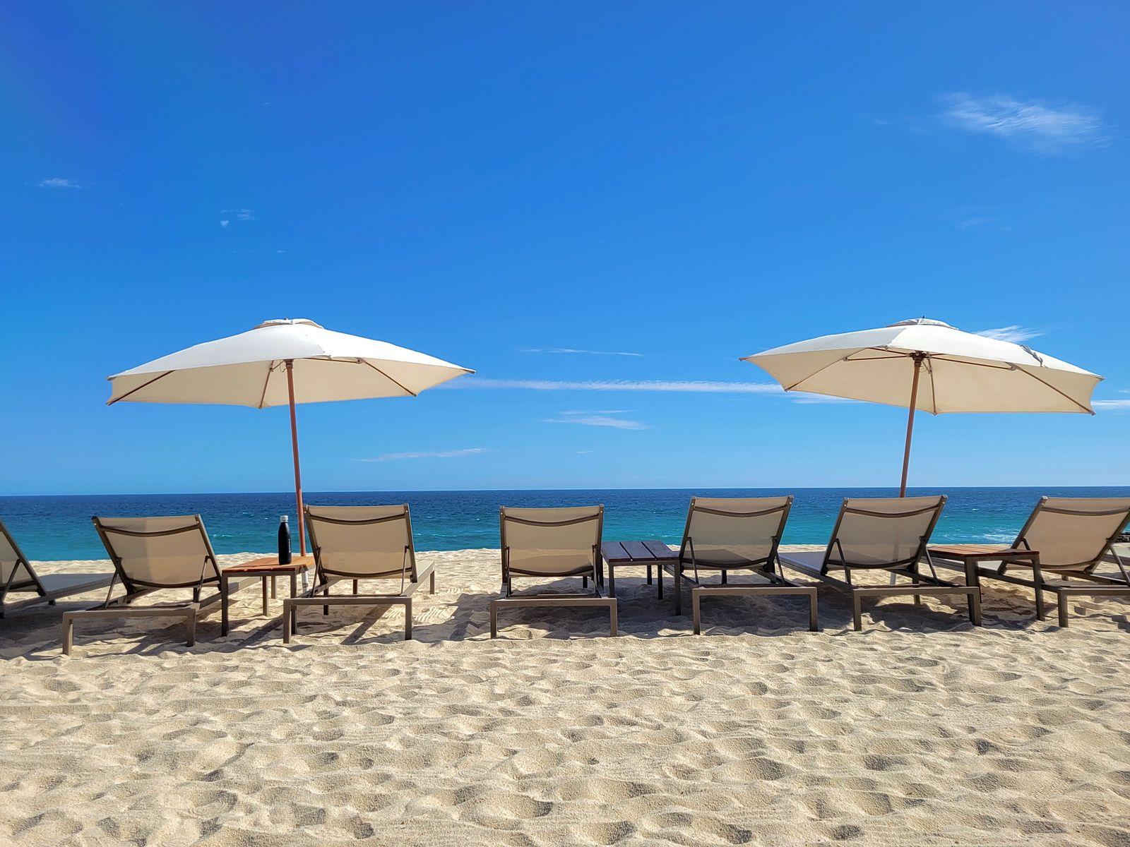 Beach umbrellas and loungers on the sand in Cabo San Lucas